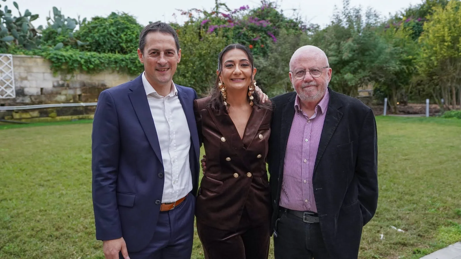 Three conference speakers together in the gardens at the previous edition